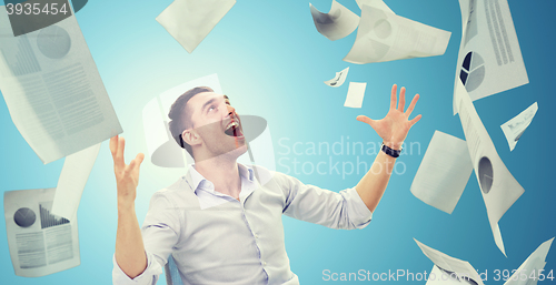 Image of businessman with falling papers