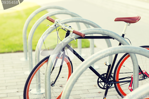 Image of close up of fixed gear bicycle at street parking