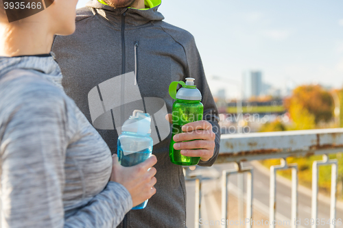 Image of close up of couple with water bottles outdoors