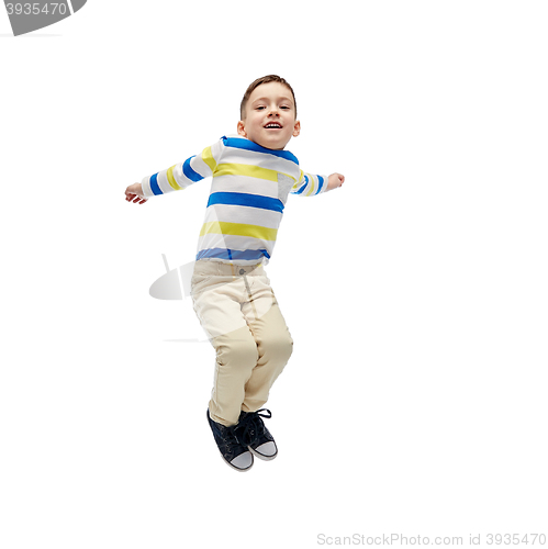 Image of happy little boy jumping in air