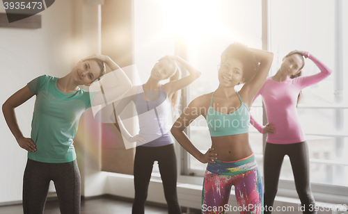Image of group of happy women working out in gym