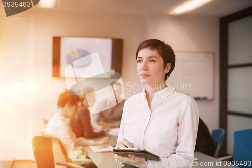 Image of business woman on meeting  using tablet computer