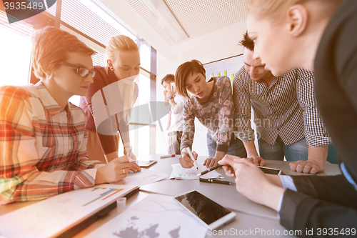 Image of startup business team on meeting at modern office with sunset in