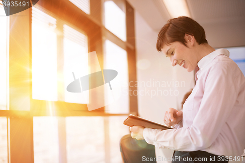 Image of business woman on meeting  using tablet computer