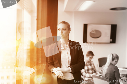 Image of portrait of young business woman at office with team on meeting 