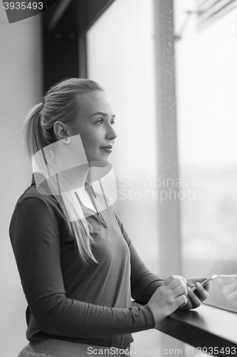 Image of business woman using smart phone at office