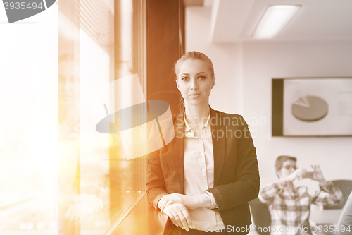 Image of portrait of young business woman at office with team on meeting 