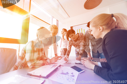 Image of startup business team on meeting at modern office with sunset in