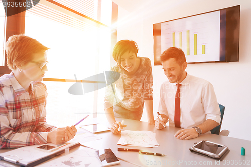 Image of startup business team on meeting at modern office with sunset in