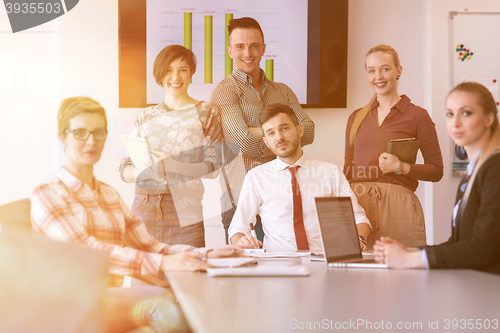 Image of startup business team on meeting at modern office with sunset in