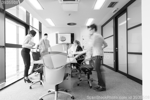 Image of business people group entering meeting room  motion blur