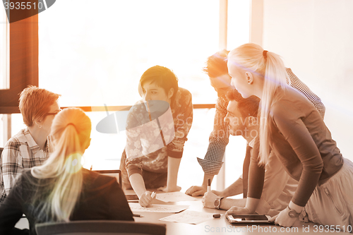 Image of startup business team on meeting at modern office with sunset in