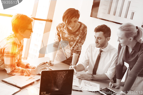 Image of startup business team on meeting at modern office with sunset in