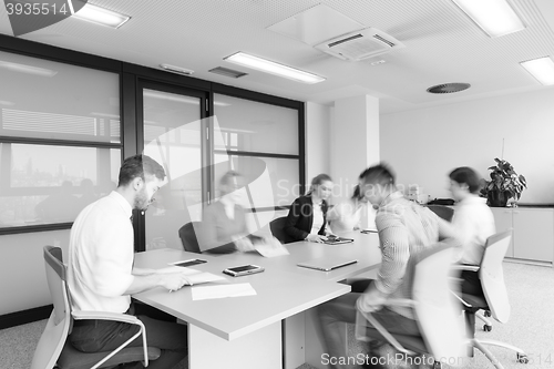 Image of business people group entering meeting room  motion blur