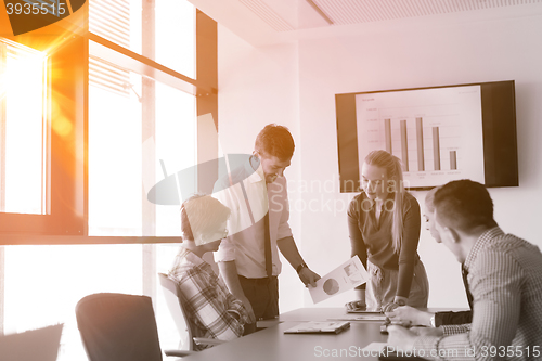 Image of startup business team on meeting at modern office with sunset in