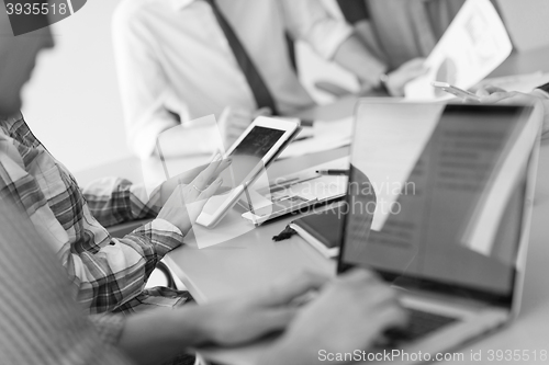 Image of close up of business man hands typing on laptop with team on mee