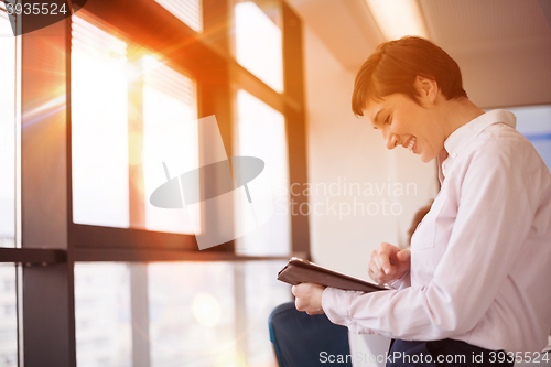 Image of business woman on meeting  using tablet computer