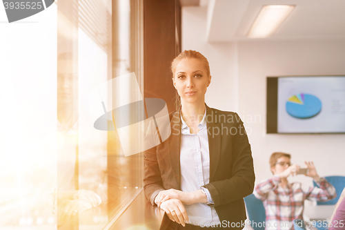 Image of portrait of young business woman at office with team on meeting 