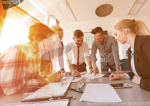 Image of startup business team on meeting at modern office with sunset in