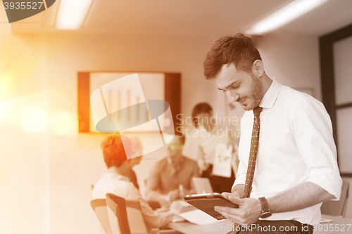 Image of young business man with tablet at office meeting room
