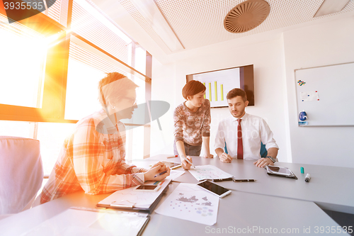 Image of startup business team on meeting at modern office with sunset in