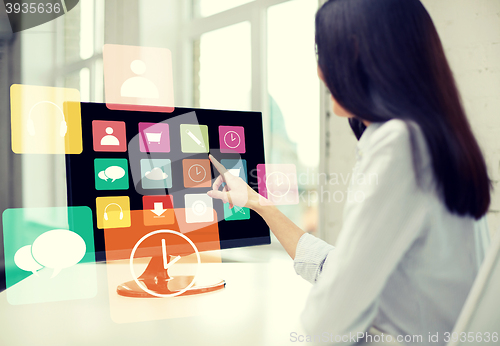 Image of close up of woman with apps on computer in office