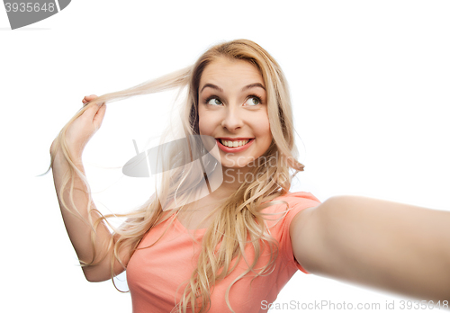 Image of smiling young woman taking selfie