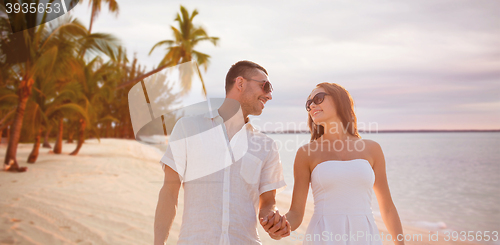 Image of happy smiling couple over summer beach and sea