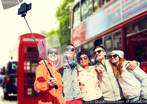 Image of friends taking selfie with smartphone in london