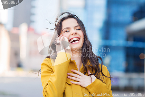 Image of smiling young woman or girl calling on smartphone