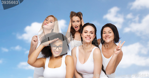 Image of group of happy women in white underwear having fun