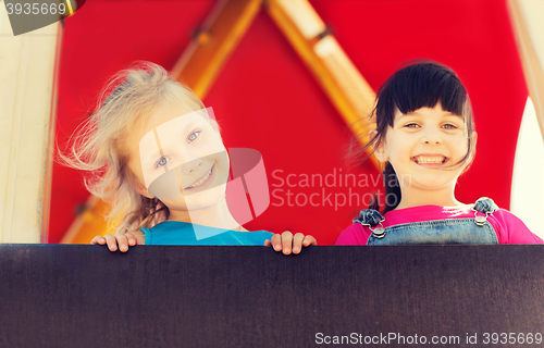 Image of group of happy little girls on children playground