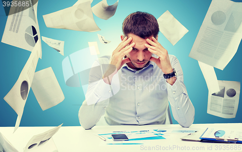 Image of close up of businessman with smartphone and papers