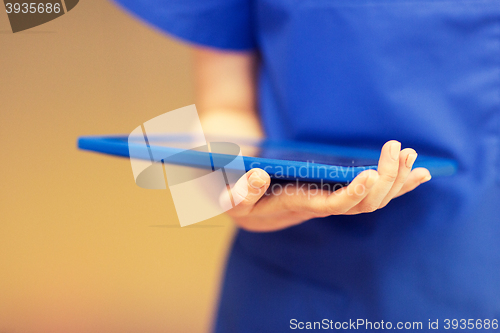 Image of close up of female doctor or nurse with tablet pc