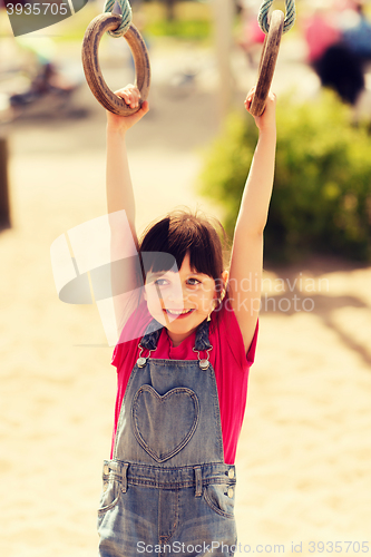 Image of happy little girl on children playground