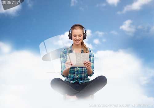 Image of woman with tablet pc and headphones