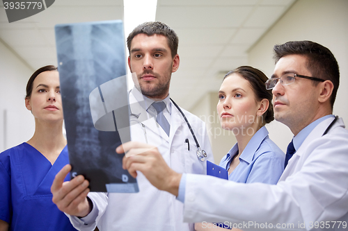 Image of group of doctors looking at x-ray scan image