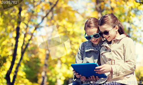 Image of happy girls with tablet pc computer outdoors