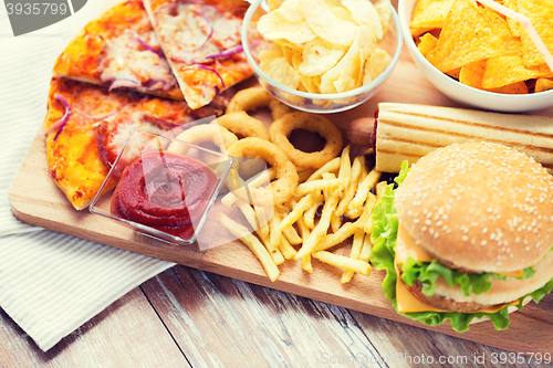 Image of close up of fast food snacks on wooden table