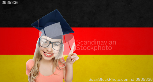 Image of smiling young student woman in mortarboard