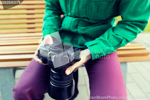 Image of close up of male photographer with digital camera