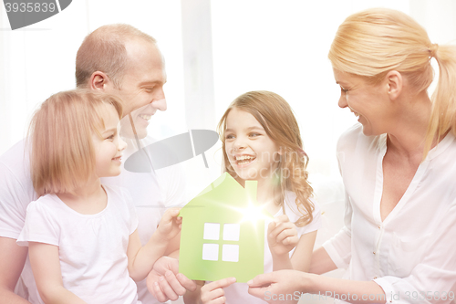 Image of smiling parents and two little girls at new home