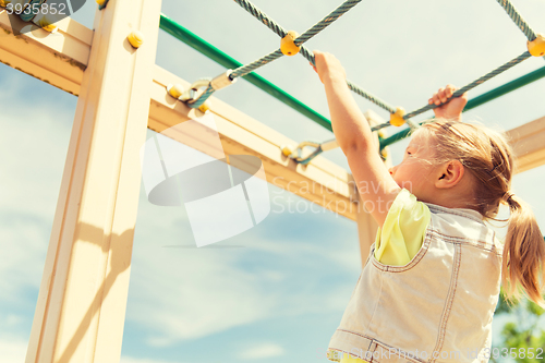 Image of close up of girl climbing on children playground