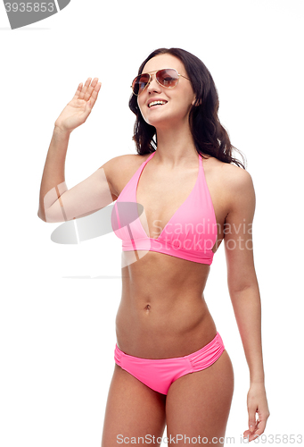Image of happy woman in sunglasses and bikini swimsuit