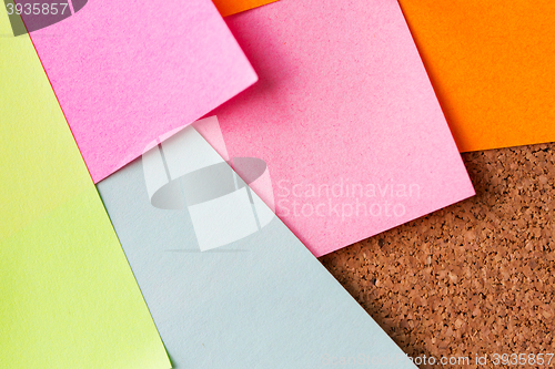 Image of close up of blank paper stickers on cork board