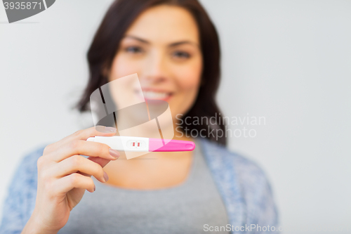 Image of close up of happy woman with home pregnancy test