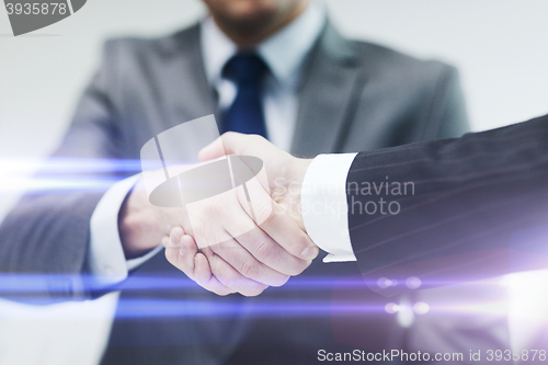 Image of two businessmen shaking hands in office