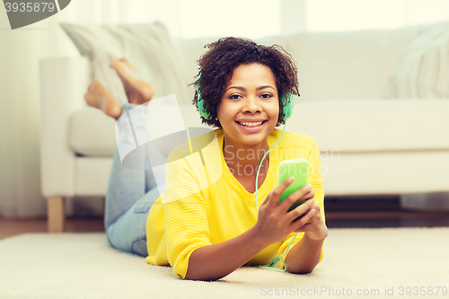 Image of happy african woman with smartphone and headphones