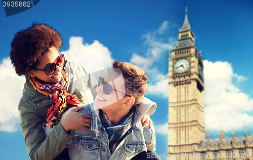 Image of happy teenage couple having fun over big ben tower