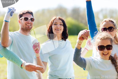 Image of group of volunteers celebrating success in park